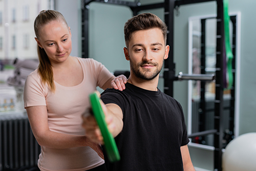 Man working out with a personal trainer at the gym